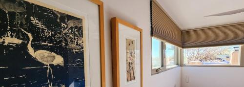 a room with a large painting on the wall and a window at Tranquil Townhome in Downtown Neighborhood in Albuquerque