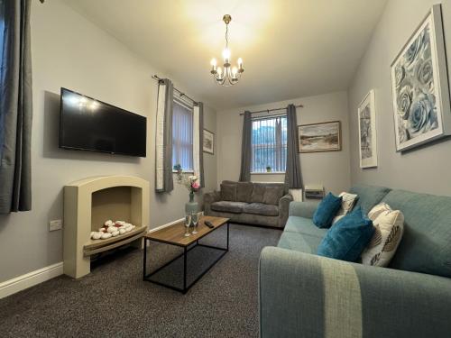 a living room with a couch and a tv at Omega Apartment - 3 Bedrooms - Sleeps 5 in Whitehaven