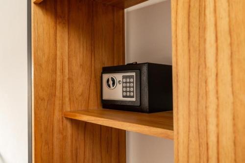 a microwave sitting on a shelf in a cabinet at Las Violetas in Luján