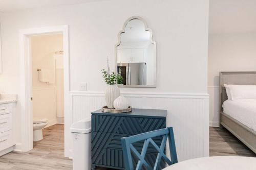a white bedroom with a blue cabinet and a bed at 3006 Queen Suite, 3rd Floor Cove in Surf City