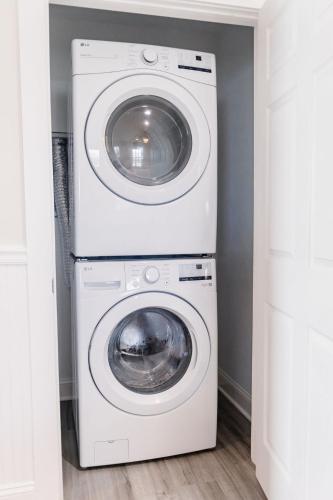 a white washer and dryer in a laundry room at 3006 Queen Suite, 3rd Floor Cove in Surf City