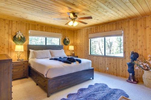 a bedroom with a bed and a ceiling fan at The Drowsy Den With Firepit & BBQ Plus Large Patio in Big Bear Lake