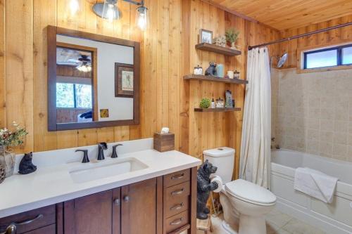 a bathroom with a sink and a toilet and a mirror at The Drowsy Den With Firepit & BBQ Plus Large Patio in Big Bear Lake