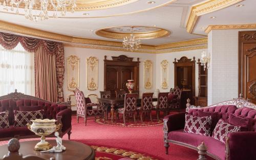 a dining room with purple furniture and a table at Shamakhi Palace Sharadil in Şǝrǝdil