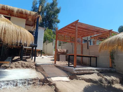 a patio with a table and a pavilion at Cabañas Martina in Cartagena