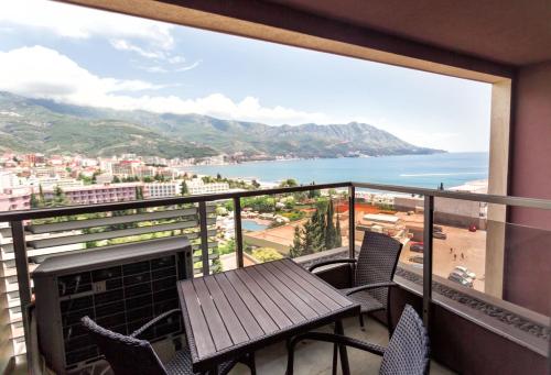 a balcony with a table and chairs and a view of the ocean at Sea View Apartments MonteBook in Becici