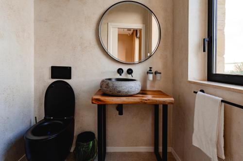a bathroom with a sink and a mirror at Elysian Fields in Mġarr