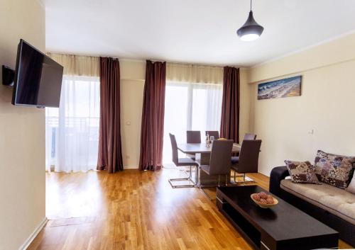 a living room with a couch and a table at Sea View Apartments MonteBook in Becici