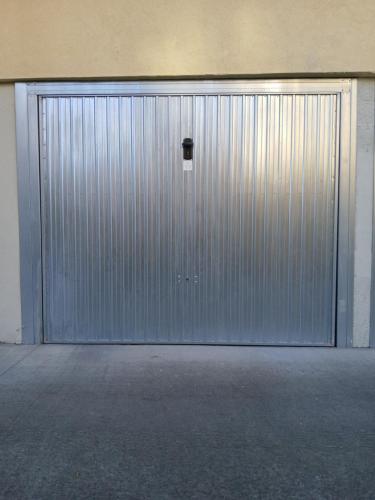 a large metal door with a small window in it at Navili Grand Apartment in Trezzano sul Naviglio