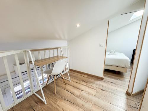 a bedroom with a bunk bed and a table and a mirror at Le Repaire de Leucate - Confort près de la Plage in Leucate-Plage