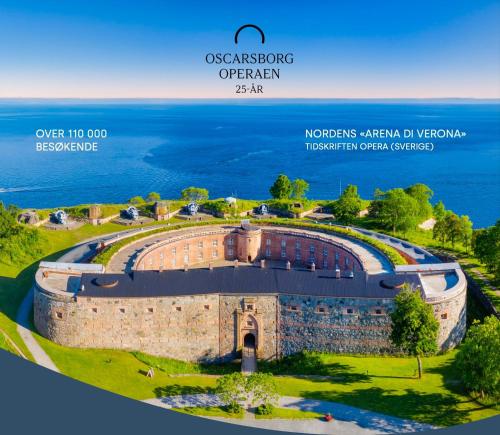 an aerial view of a building with the ocean in the background at Villa Thorse in Husvik