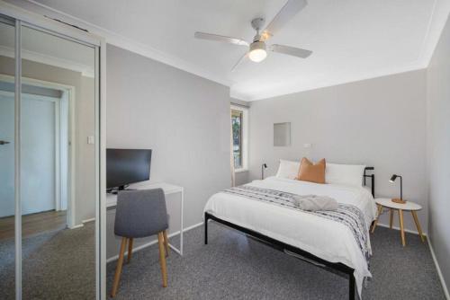 a bedroom with a bed and a tv and a mirror at Waterways in North Haven