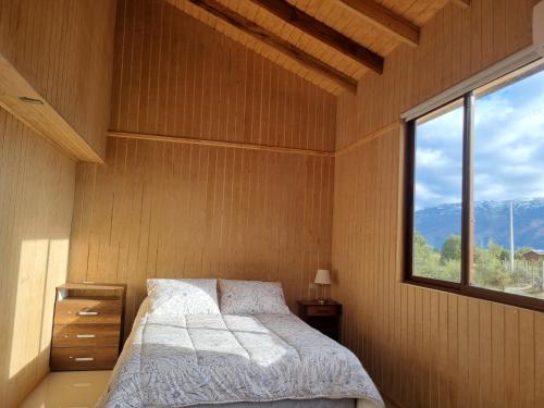 a bedroom with a bed and a window at Turismo Volcán Antuco in Antuco