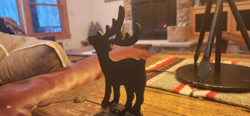 a black figurine of a deer on a table at Sundance Spacious Vaulted Ceiling cabin, Hot tub, huge lawn in Sundance
