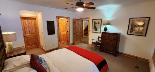 a bedroom with a bed and a ceiling fan at Sundance Spacious Vaulted Ceiling cabin, Hot tub, huge lawn in Sundance