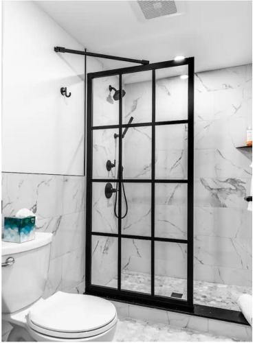 a bathroom with a toilet and a glass shower at The Phenix Historic DTWN Hotel, Room # 310 in Bangor