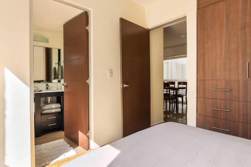 a bedroom with wooden cabinets and a mirror at C101 - 2BR - 2BTh in Mexico City