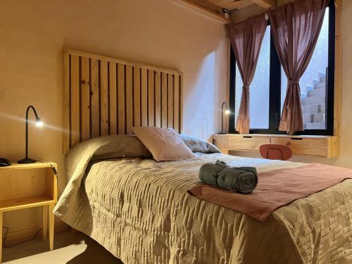 a bedroom with a bed and a large window at Casa Coco H2 Arena in San Cristóbal de Las Casas