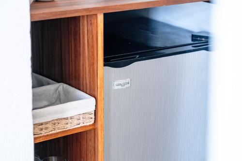 a shelf with a small refrigerator in a kitchen at Casa Manglar Riviera Maya in Puerto Aventuras