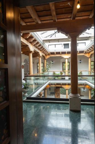 a large building with a pool and escalators at Indian Palace Hotel Boutique Spa & Restaurante in Antigua Guatemala