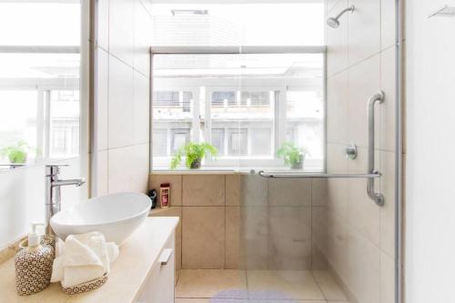 a bathroom with a shower with a sink and a tub at J607 - 2BDR - 1BTh in Mexico City