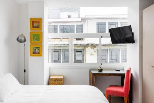 a bedroom with a bed and a desk and a tv at J607 - 2BDR - 1BTh in Mexico City