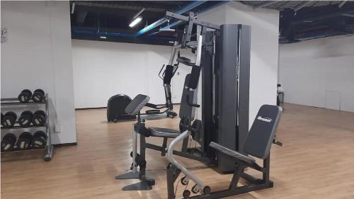 a gym with several tread machines in a room at J607 - 2BDR - 1BTh in Mexico City