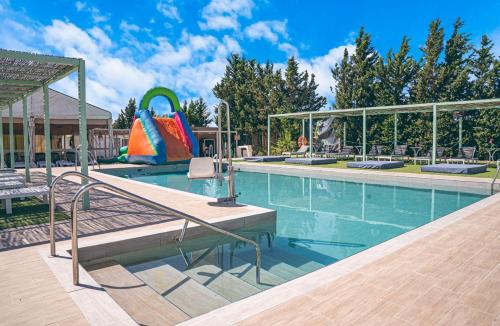 a swimming pool with a slide in the middle at Hotel La Villoría in Medina Sidonia