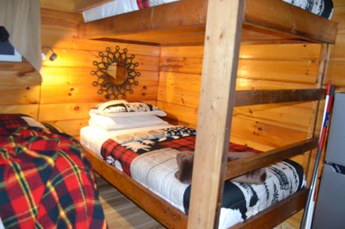 a bedroom with two bunk beds in a cabin at Campfire Cabin, Red River Gorge, KY, River Access & Views in Stanton