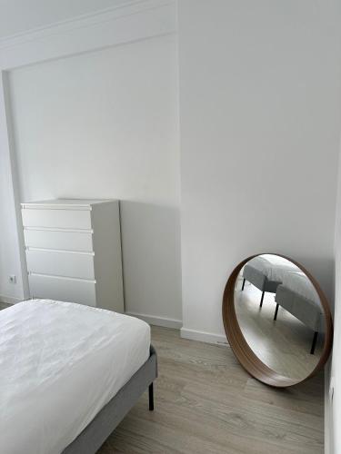 a bedroom with a round mirror on the floor at CL Group Guest House in Cacém