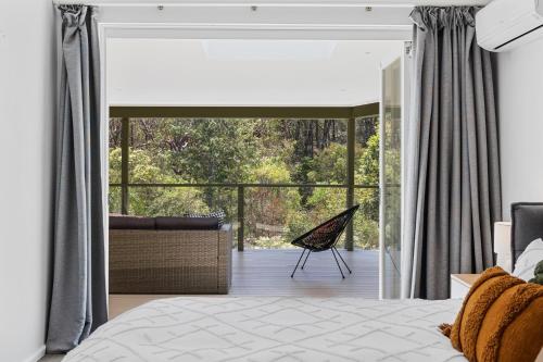 a bedroom with a large glass door leading to a patio at Poolside oasis - Sydney in Sydney
