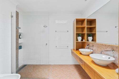 a bathroom with two sinks and a shower at Poolside oasis - Sydney in Sydney