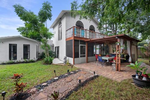a house with a deck and a patio at Chic 4BR Home Hot Tub Game Room in Port Saint Lucie