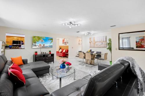 a living room with a couch and a table at Chic 4BR Home Hot Tub Game Room in Port Saint Lucie