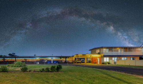 a house under a night sky with the milky way at RAMS Motel in Coonamble