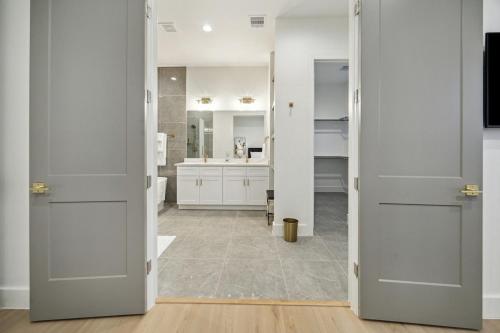 a bathroom with white walls and white doors at Houston- Downtown, NRG, Med Center, City Views, U of H & TSU in Houston