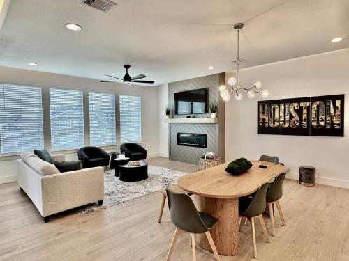 a living room with a table and chairs and a couch at Houston- Downtown, NRG, Med Center, City Views, U of H & TSU in Houston