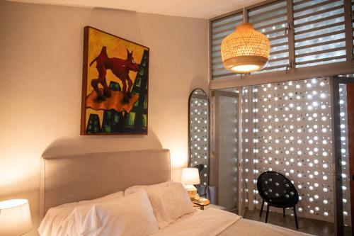 a bedroom with a bed and a window with lights at Casa Bajura Bed and Breakfast in Isabela