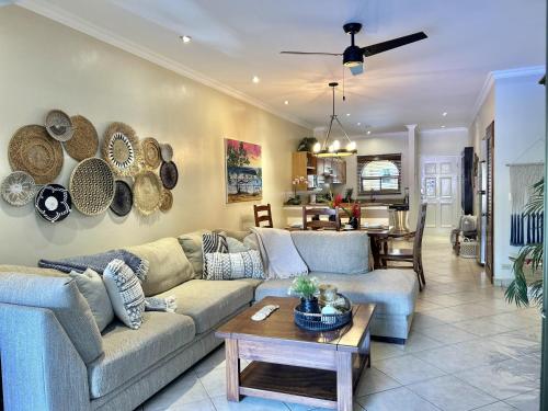 a living room with a couch and a table at Sunrise 1- 3 Bedroom Poolside Condo in Tamarindo