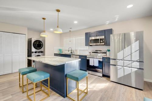 a kitchen with blue cabinets and blue stools at Chic home with king bed in Raleigh in Raleigh
