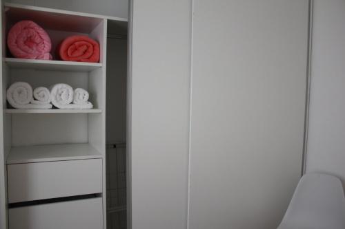 a closet with white shelves with towels in it at Pueblo Dorado in Malargüe