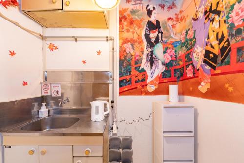 a kitchen with a sink and a painting on the wall at LEON RESORT HOTEL B 4rooms MAX14people 6min Shinjuku 11min Shibuya 12min walk Ikebukuro LEON RESORT IKEBUKURO traditional Japanese room 池袋 最大14名 in Tokyo