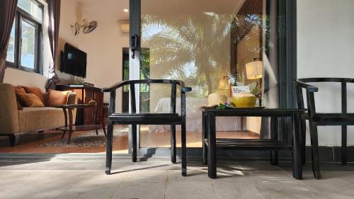 two black chairs sitting in a living room at ZEN Resort - Villa beach- Garden in Xóm Tram