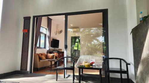 a room with a table and chairs and a mirror at ZEN Resort - Villa beach- Garden in Xóm Tram