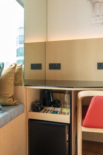 a kitchen with a counter top and a table at Ibis Singapore on Bencoolen - Newly Renovated in Singapore
