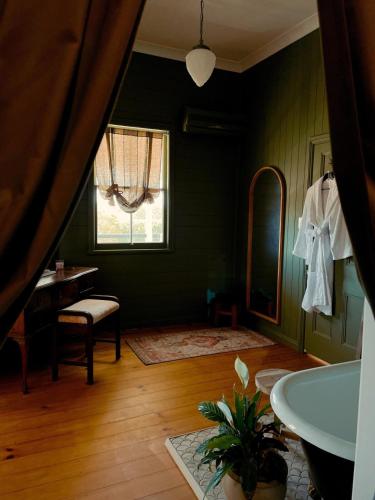 a bathroom with a tub and a chair and a window at Linning's House at Twigley Farm in Marburg