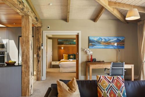a living room with a couch and a bedroom at Chambers City Centre Penthouse in Queenstown