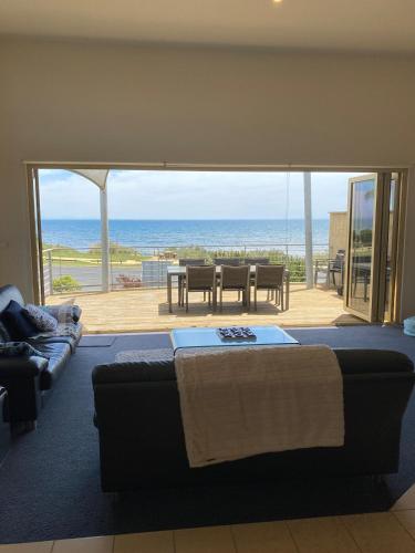 a living room with a bed and a view of the ocean at Seaview on The Esplanade in Portarlington