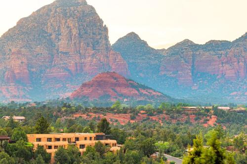 a view of a mountain range with a building and trees at Sky Rock Sedona, a Tribute Portfolio Hotel in Sedona
