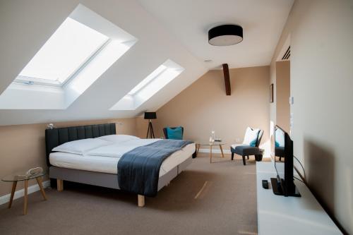 a bedroom with a bed and a skylight at Braun Rooms Deluxe in Sopron